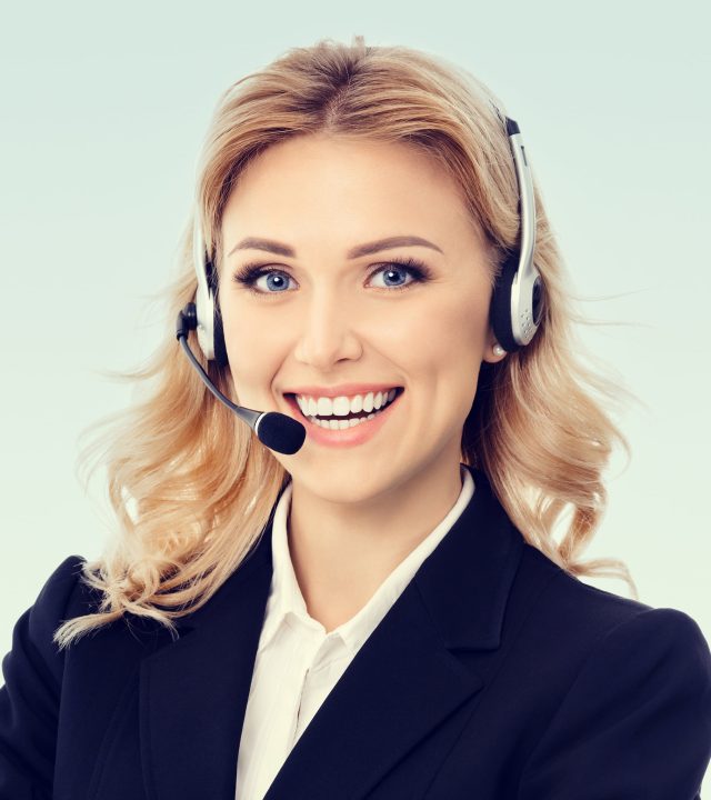 Call Center Service. Photo of customer support agent. Female caller or receptionist phone operator. Help line answering and telemarketing. Blond caucasian girl in black confident jacket, at studio picture. Square composition.